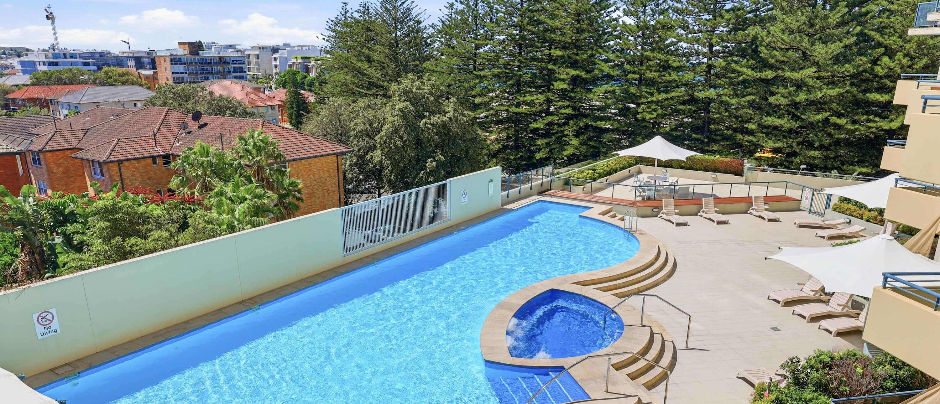Resort-style pool at a Cronulla apartment building where MetaWise manages apartments, the beach behind.