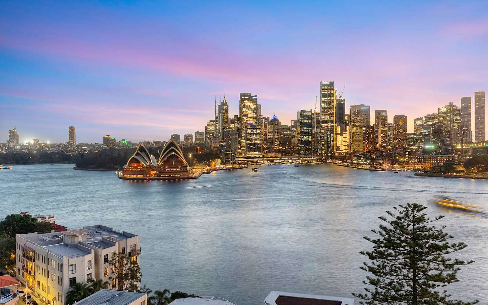 Sydney skyline and the Opera House at sunset, seen across the harbour from Kirribilli.